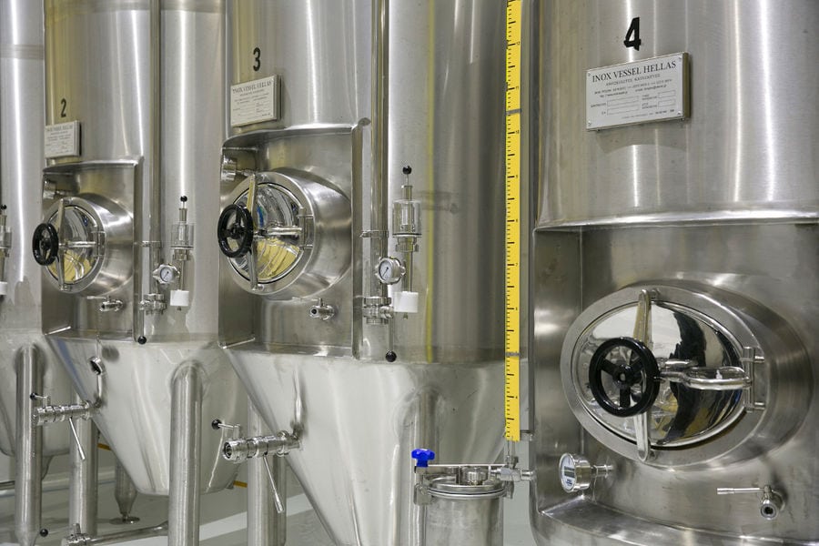 view of the base of aluminum beer tanks at 'Sknipa' plant